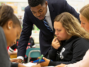 Teacher working with middle school students.