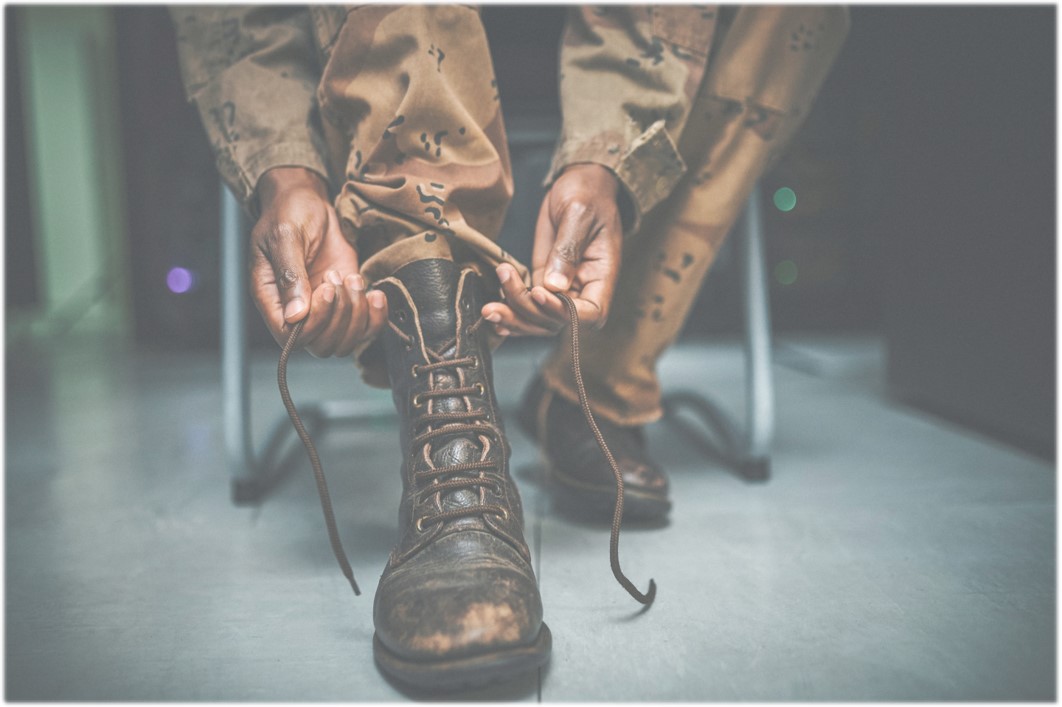 Military person tying their boots